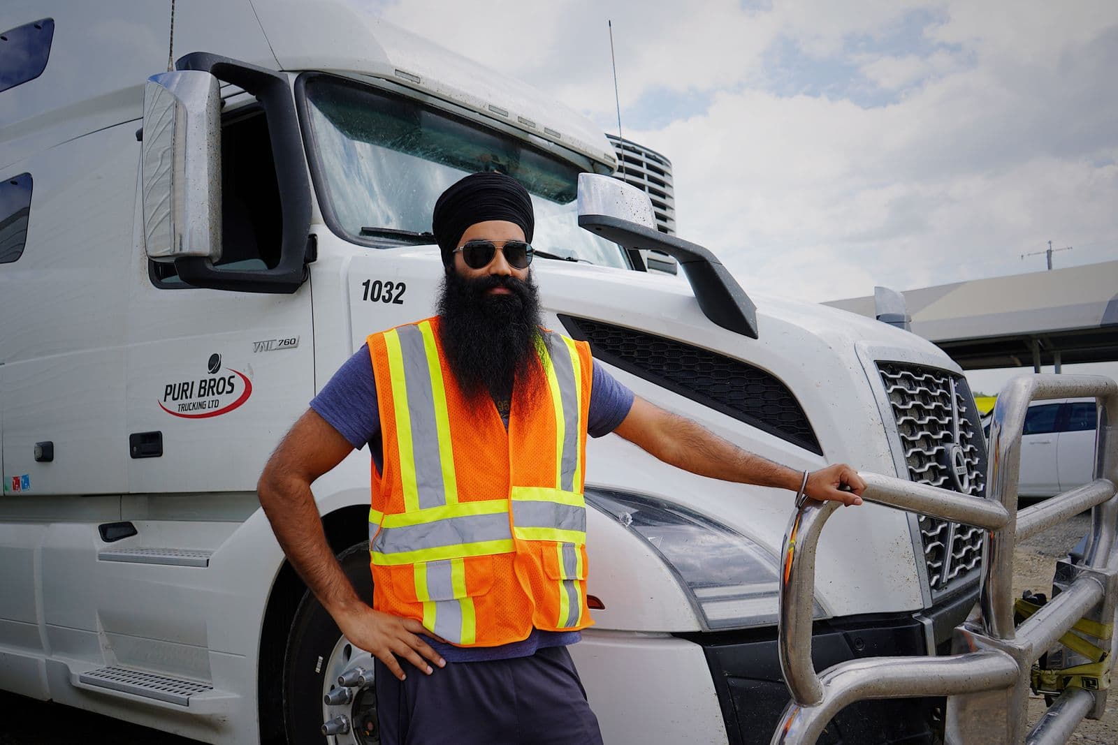 Owner-operator standing beside his semi-truck, ready for the road